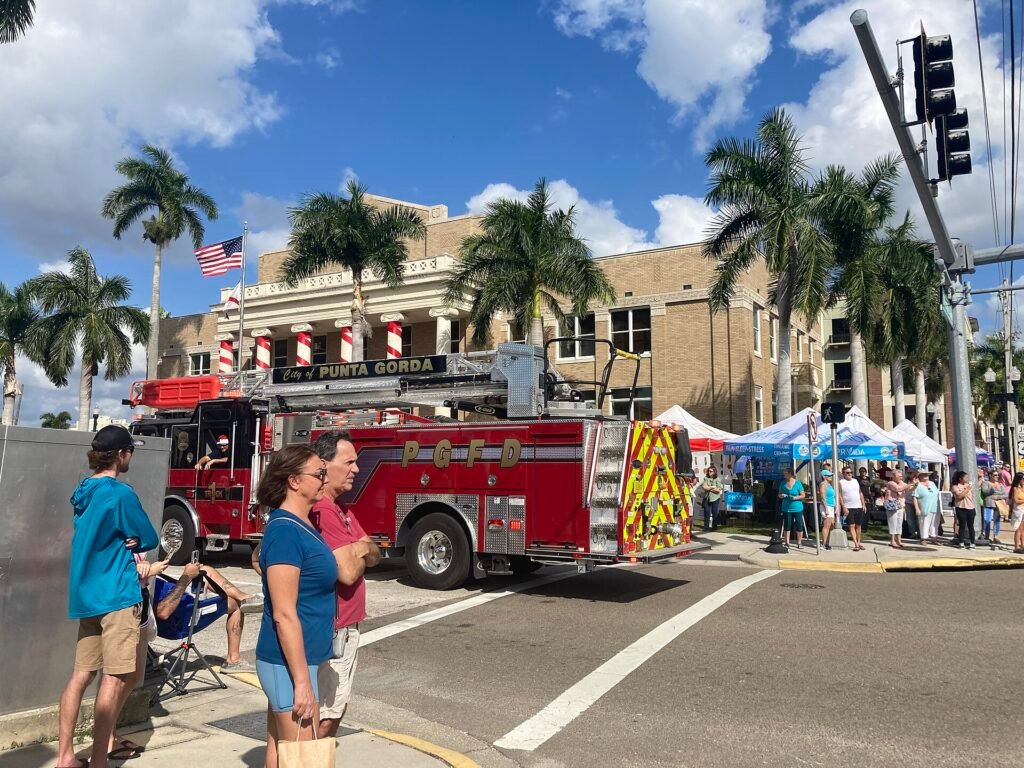 Punta Gorda firefighters riding a truck in the Christmas parade